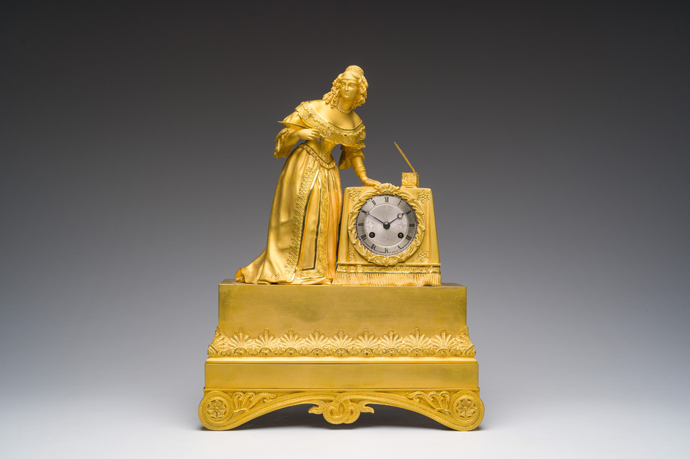 A fine French gilt bronze mantel clock crowned with a writing lady, 19th C.