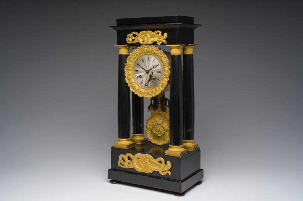 A French bronze mounted ebonized wooden column mantel clock, 19th C.