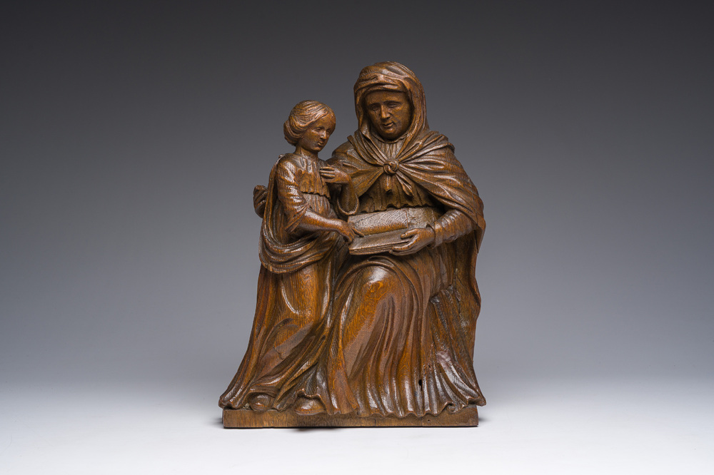 A Flemish oak group depicting Saint Anne teaching Mary to read, 19th C.