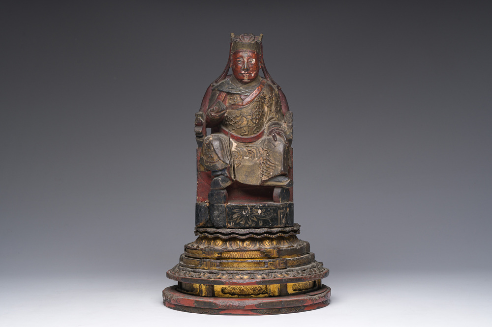 A Chinese gilt-lacquered wood sculpture of a dignitary, 19th C.