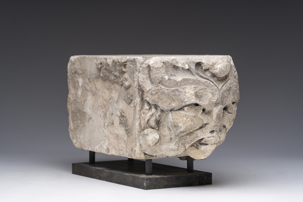 A Romanesque carved stone corbel with a grotesque head, probably France, 14th/15th C.