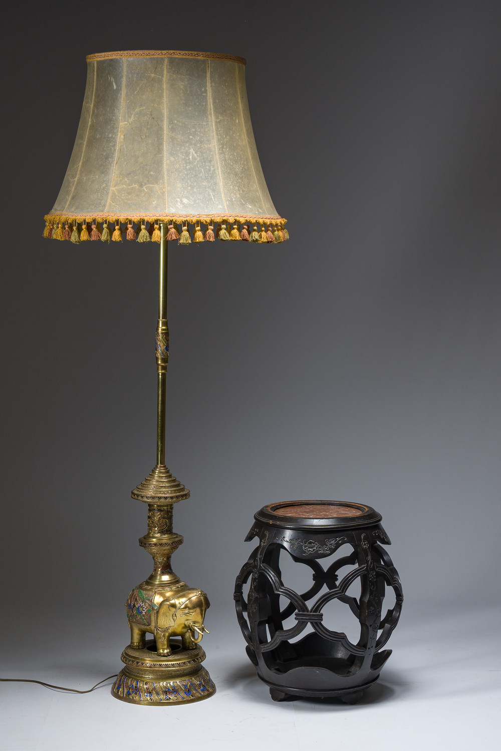A reticulated Chinese wooden stand with marble top and a French gilt brass and champlev&eacute; 'elephant' lamp, 20th C.