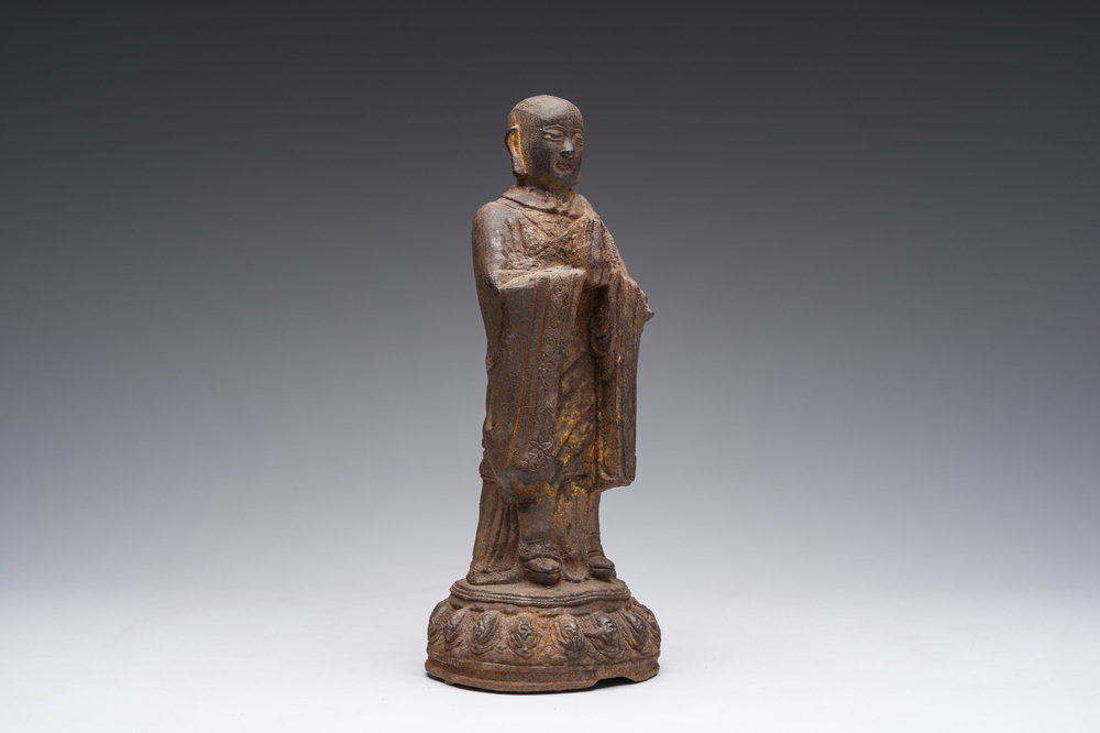 A Chinese cast iron sculpture of a Luohan, probably Ming