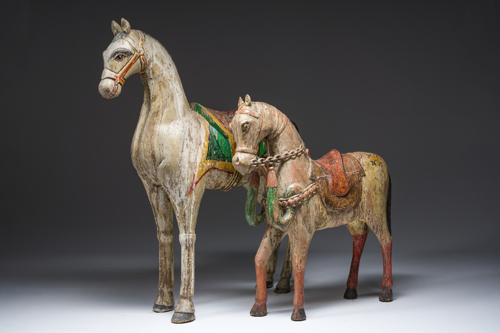 Two Indian polychrome decorated and patinated wooden horses, 20th C.
