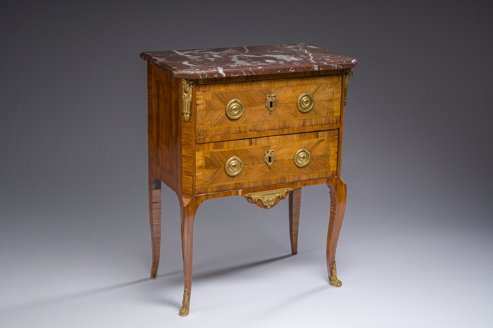 Jacques-Pierre Letellier (ca.1745-?): A mahogany veneer Louis XVI chest of drawers with gilt bronze mounts and red marble top