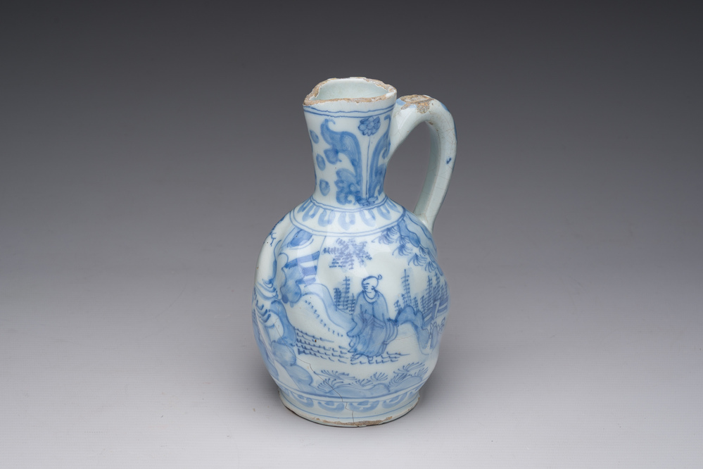 A twisted blue and white Dutch Delft chinoiserie jug, 17th C.