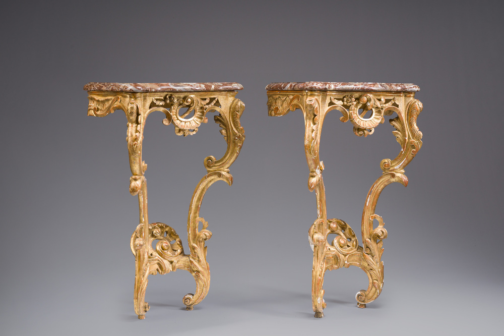 A pair of French carved gilt wooden Louis XV consoles with marble tops, 18th C.