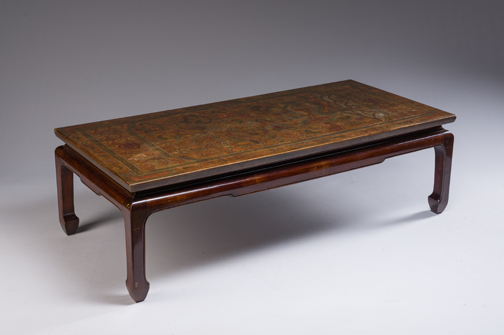 A Chinese low table with partly polychromed wooden top with engraved dragon and phoenix design, Qing and 20th C.
