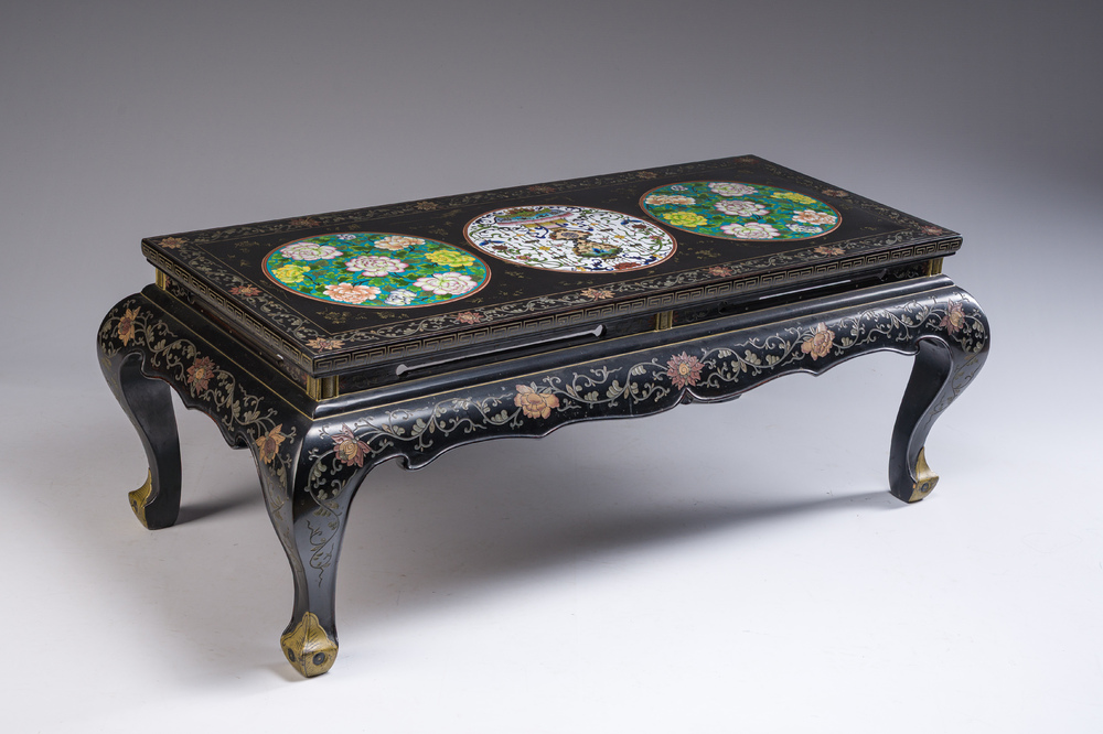 A Chinese rectangular lacquered wooden table with three cloisonn&eacute; plaques, 20th C.