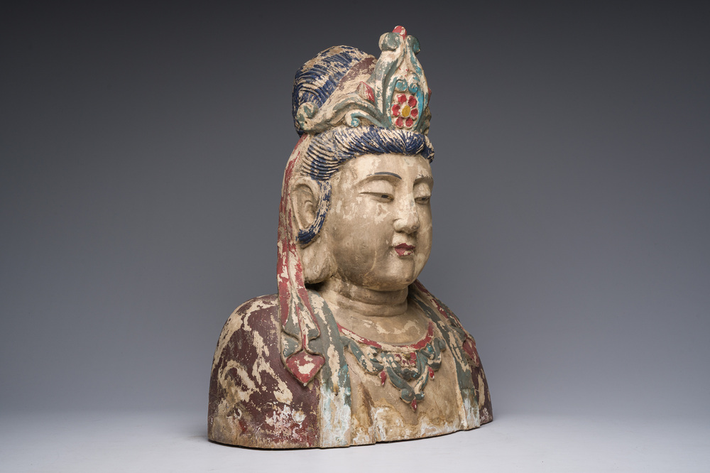 A large Chinese polychromed wooden bust of Buddha, 20th C.