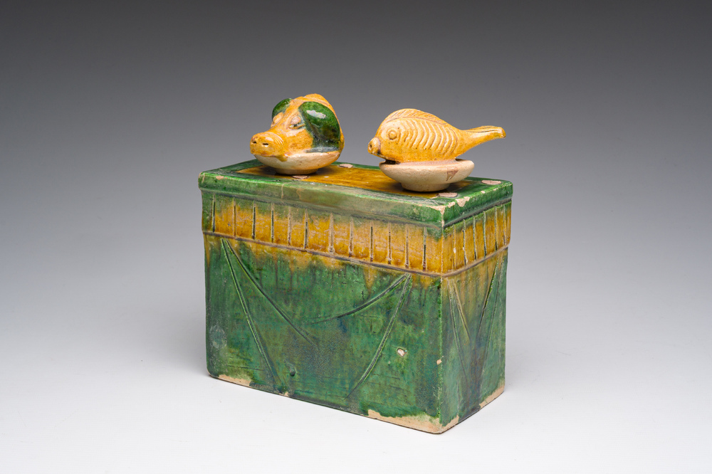 A Chinese sancai glazed miniature offering table with a fish and a pig's head, probably Ming