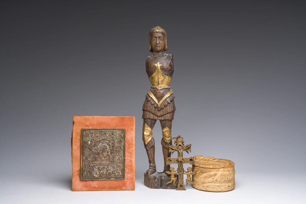 A Flemish parcel-gilt wooden 'soldier', a double-sided bronze cross, a Russian orthodox travel icon and a carved stone box and cover, 16th C. onwards