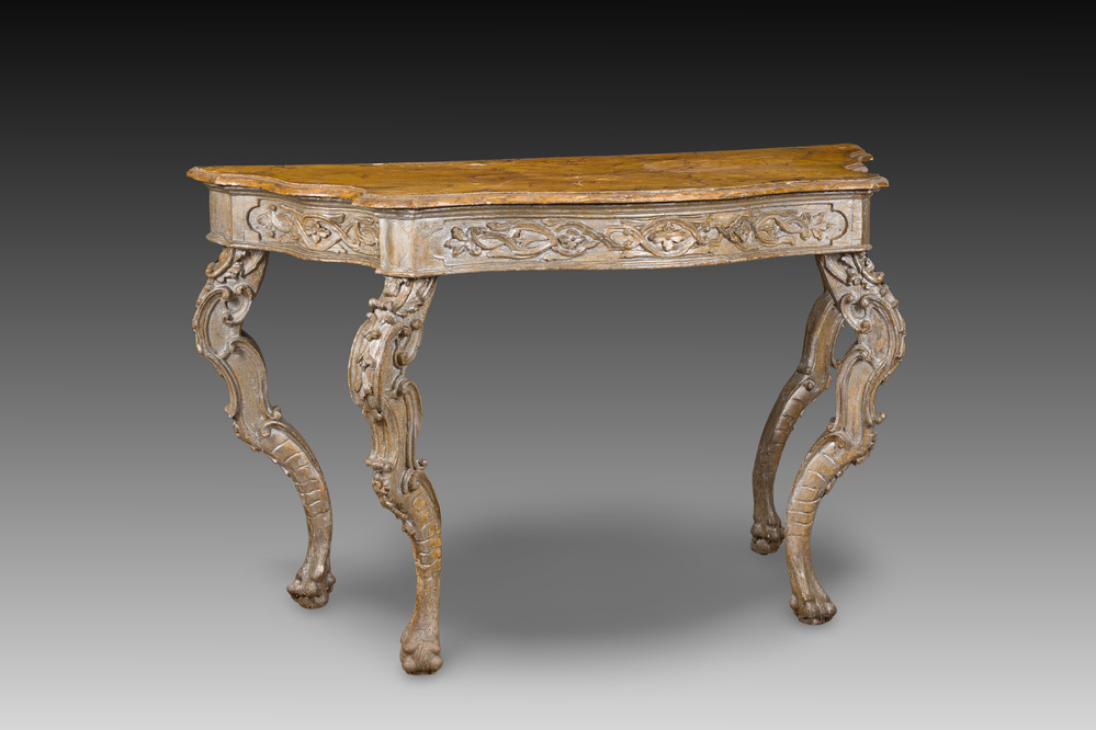An Italian patinated wooden console with a faux marble top and lion paws, 18th C.