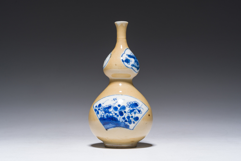 A Chinese blue and white caf&eacute;-au-lait-ground double gourd vase, Kangxi