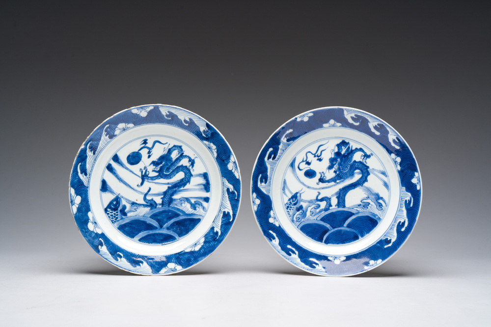 A pair of Chinese blue and white 'dragon and carp' plates, Kangxi