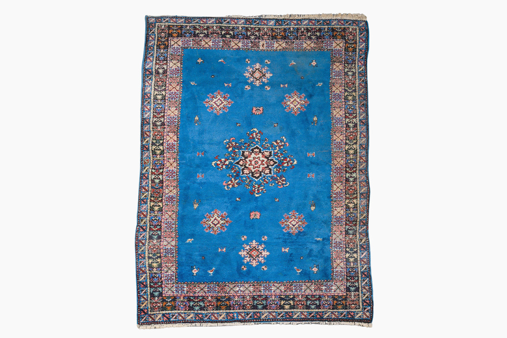 A presumably Tunisian rug with a central medallion, wool on cotton, 20th C.