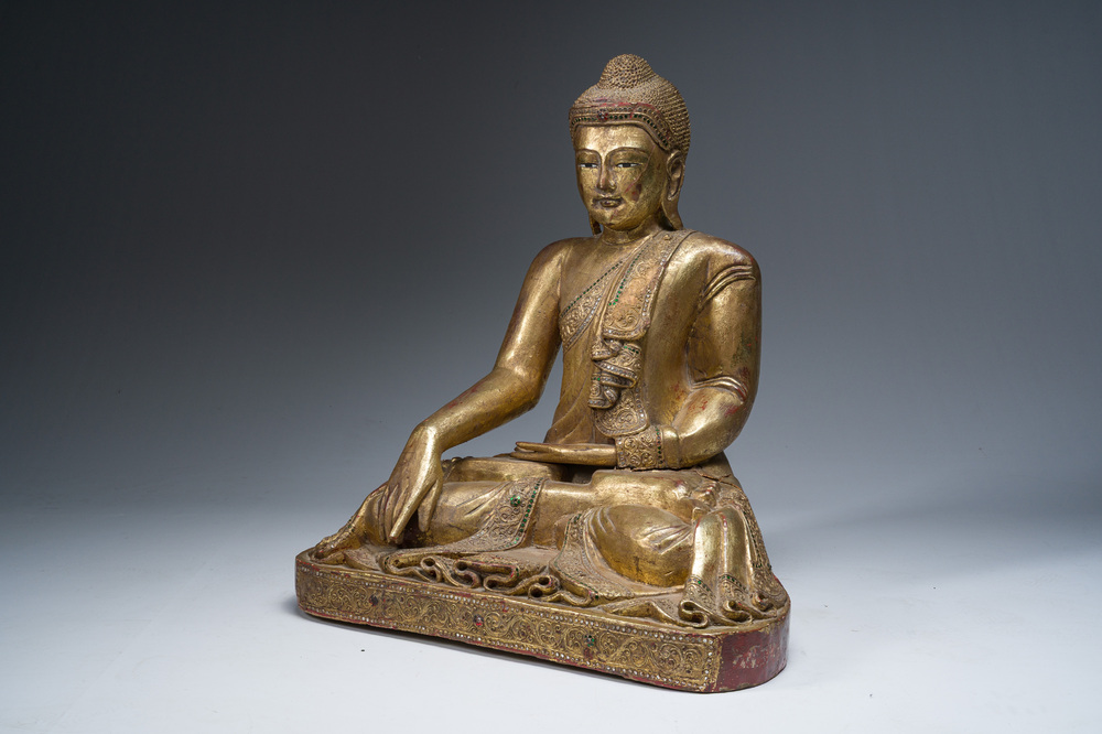 A tall Thai inlaid partly gilt lacquered wooden figure of a seated Buddha, 19th/20th C.