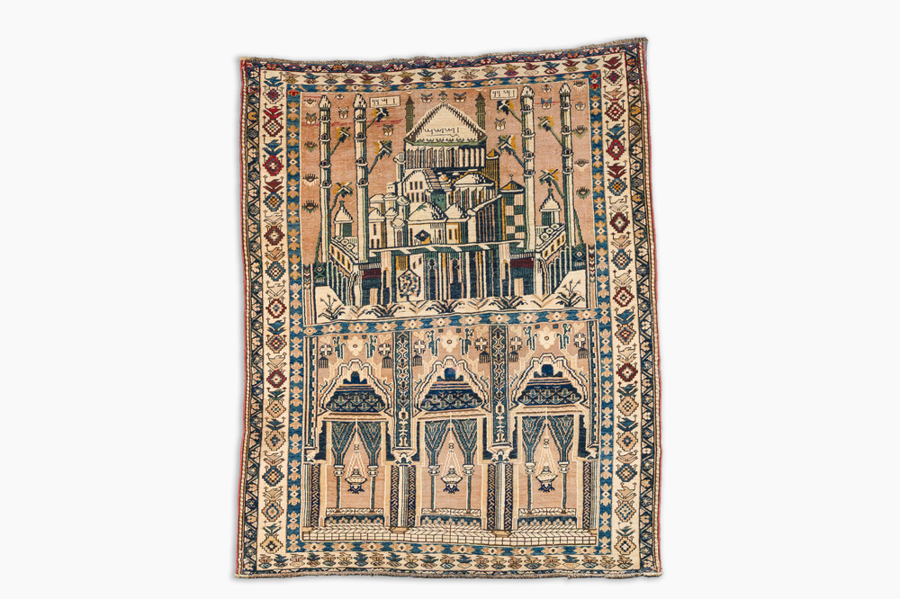 A Caucasian wool Baluch (Balochi) or Shirvan carpet depicting a mosque, dated 1943