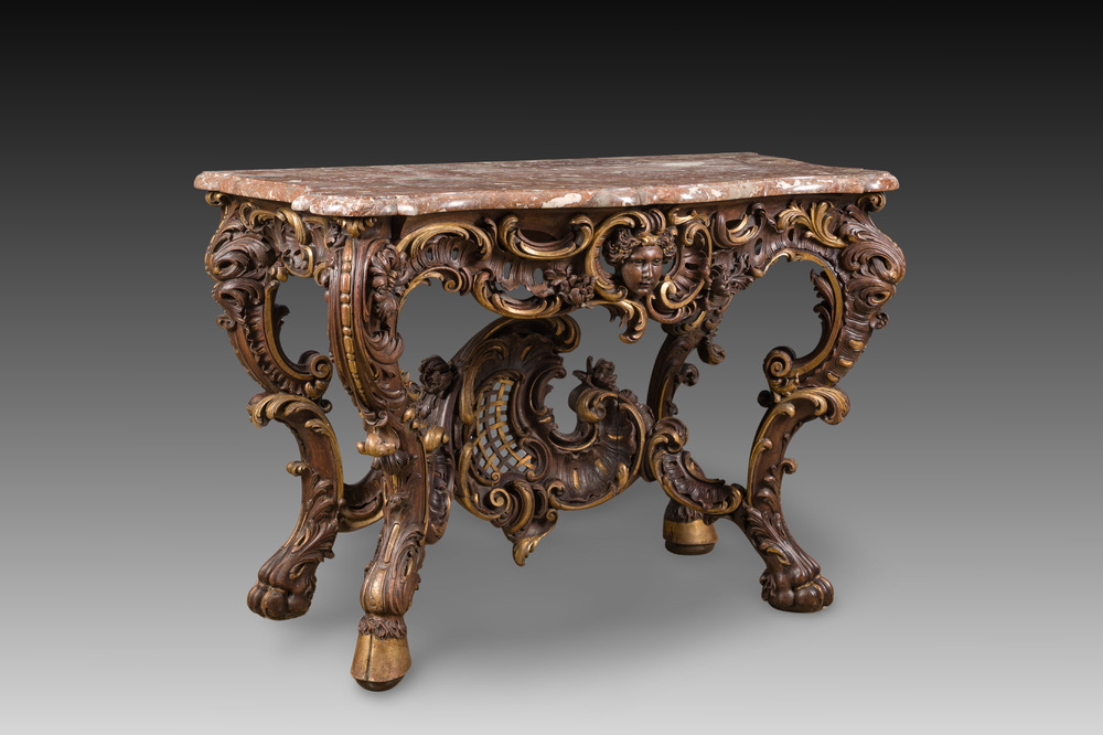An impressive parcel-gilt and patinated wooden console in Rococo style, probably Italy, 19th C.