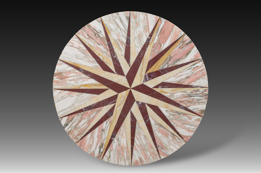 A round Italian pietra dura table top with a sixteen-pointed star, 20th C.