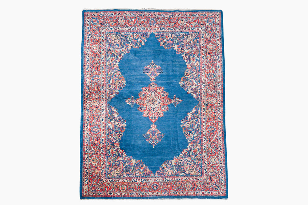 A Persian Sarouk rug with central medallion and floral design, wool on cotton, 20th C.