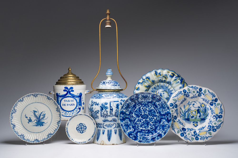 Five blue, white and polychrome Dutch Delft dishes, a lamp-mounted vase and a Brussels faience tobacco jar, 17th/19th C.