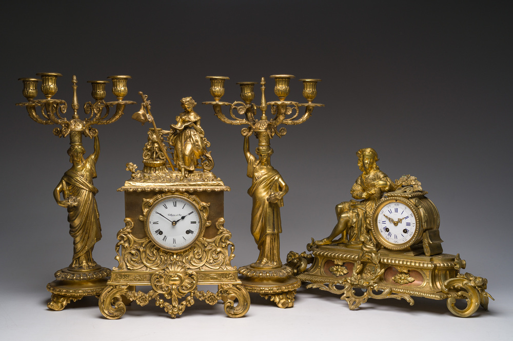 Two gilt bronze mantel clocks and a pair of four-light caryatid-shaped candlesticks, France and Germany, 19th/20th C.