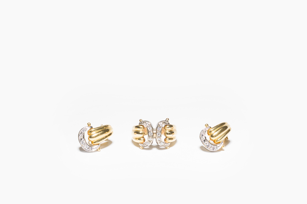 A pair of Cartier style gold earrings and a ring set with diamonds, 20th C.