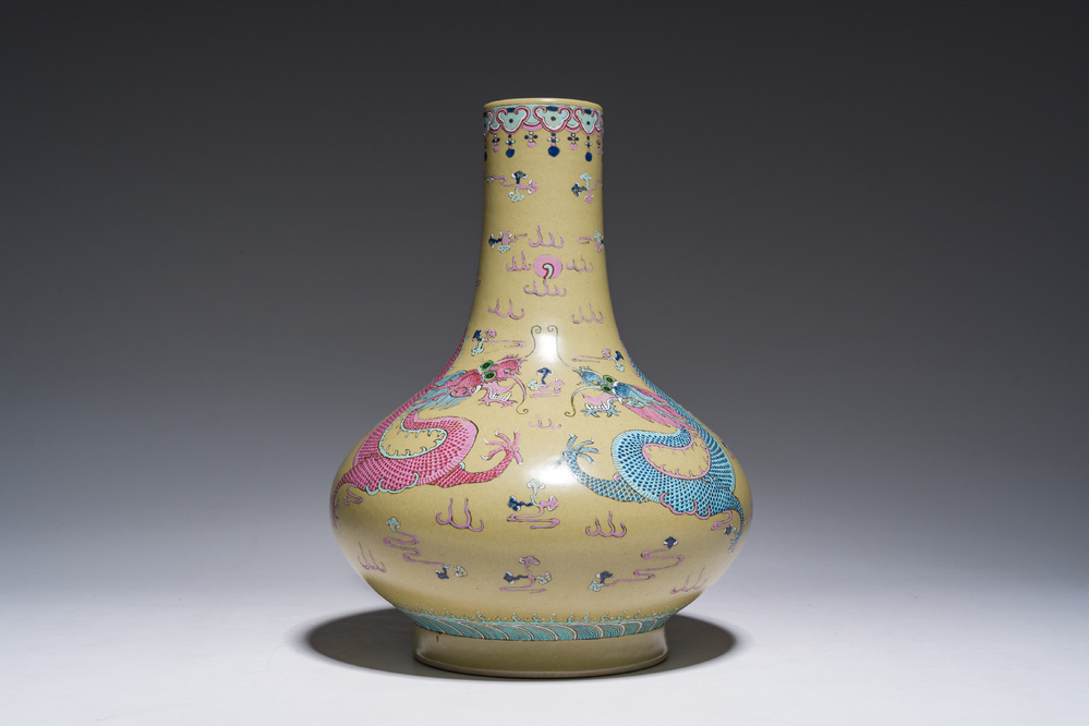 A Chinese famille rose enamelled teadust-glazed bottle vase with dragons, Qianlong mark, 19th C.