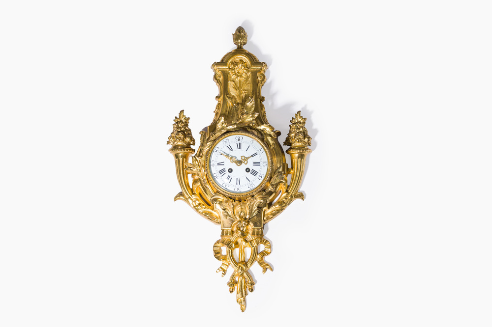 A French gilt bronze Louis XVI style cartel clock with floral design, late 19th C.