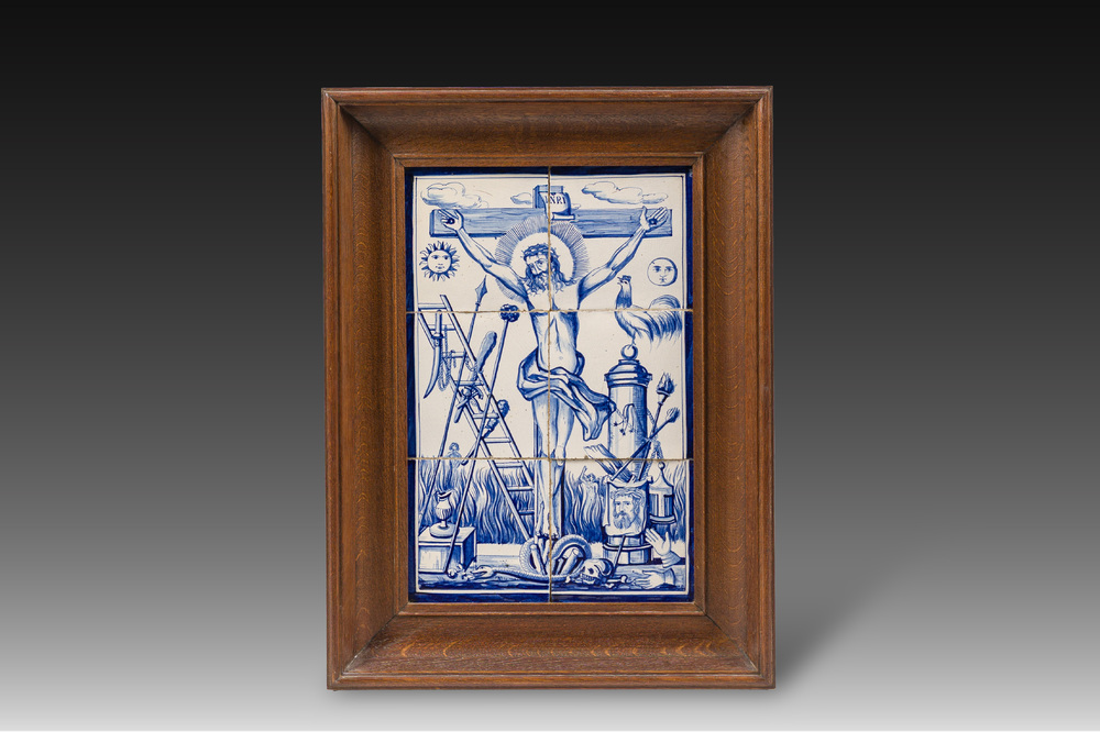 A blue and white Dutch Delft tile mural with Christ on the cross surrounded by the Instruments of the Passion, 19th/20th C.