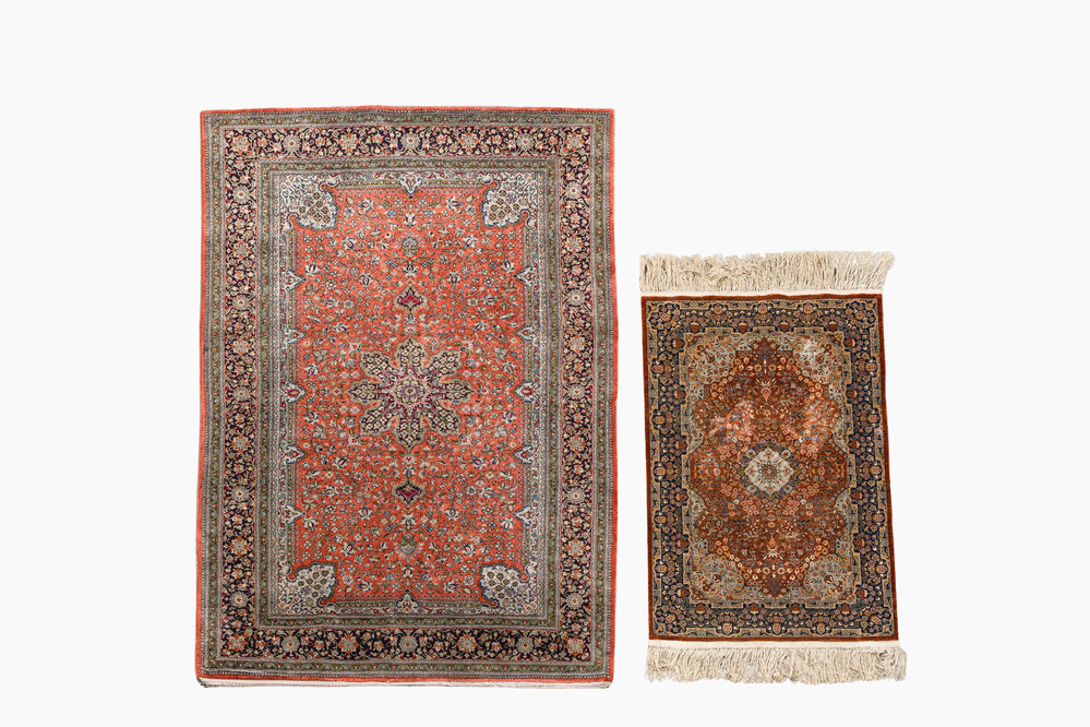 A Persian Qom (Qum/Ghom) silk rug and a Chinese silk Hereke style rug with floral design, 20th C.