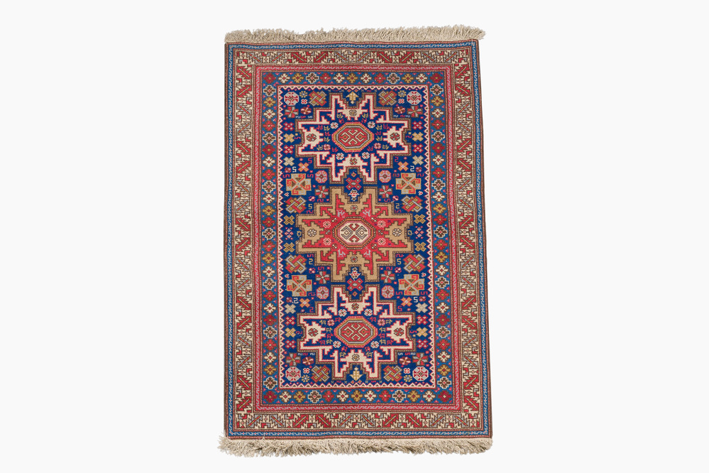 An Afghan Shirvan rug with geometric floral design, wool on cotton, mid 20th C.