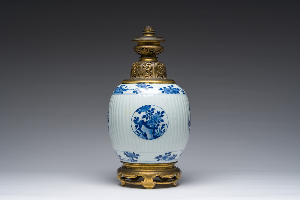A Chinese blue and white vase with floral design with gilt bronze mounts mounted as a lamp, Kangxi