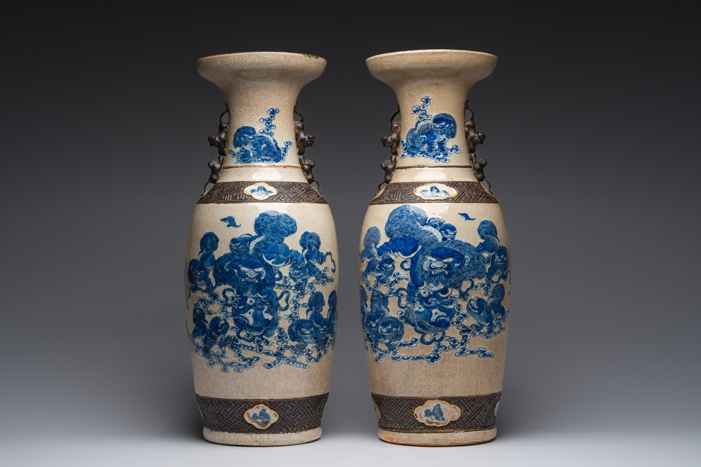 A pair of Chinese Nanking crackle glazed blue and white vases with Buddhist lions and birds among blossoming branches, 19th C.