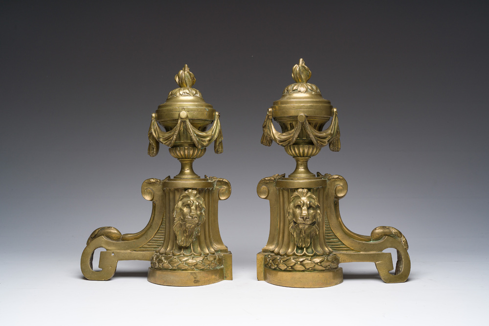 A pair of French Louis XVI style gilt bronze andirons with lion heads and garlands, ca. 1900