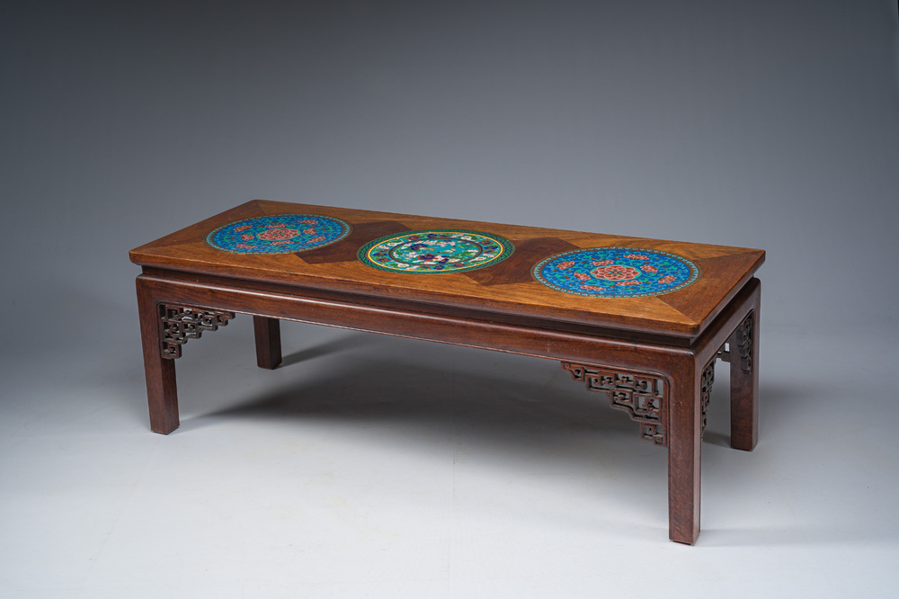 A Chinese rectangular wooden table inlaid with three round cloisonn&eacute; plaques with floral design, 20th C.