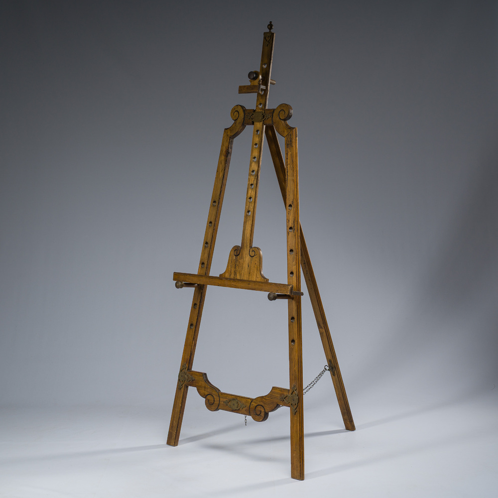 A carved walnut painter's easel with brass mounts, early 20th C.