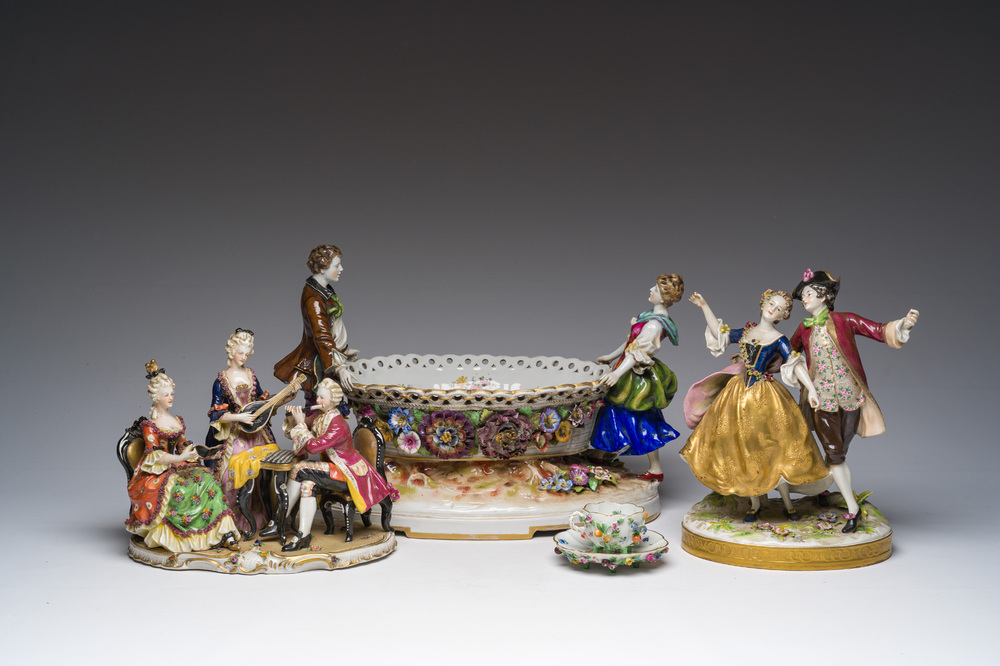 Two polychrome Saxon porcelain groups, a table piece and a cup and saucer, Germany, 19th/20th C.