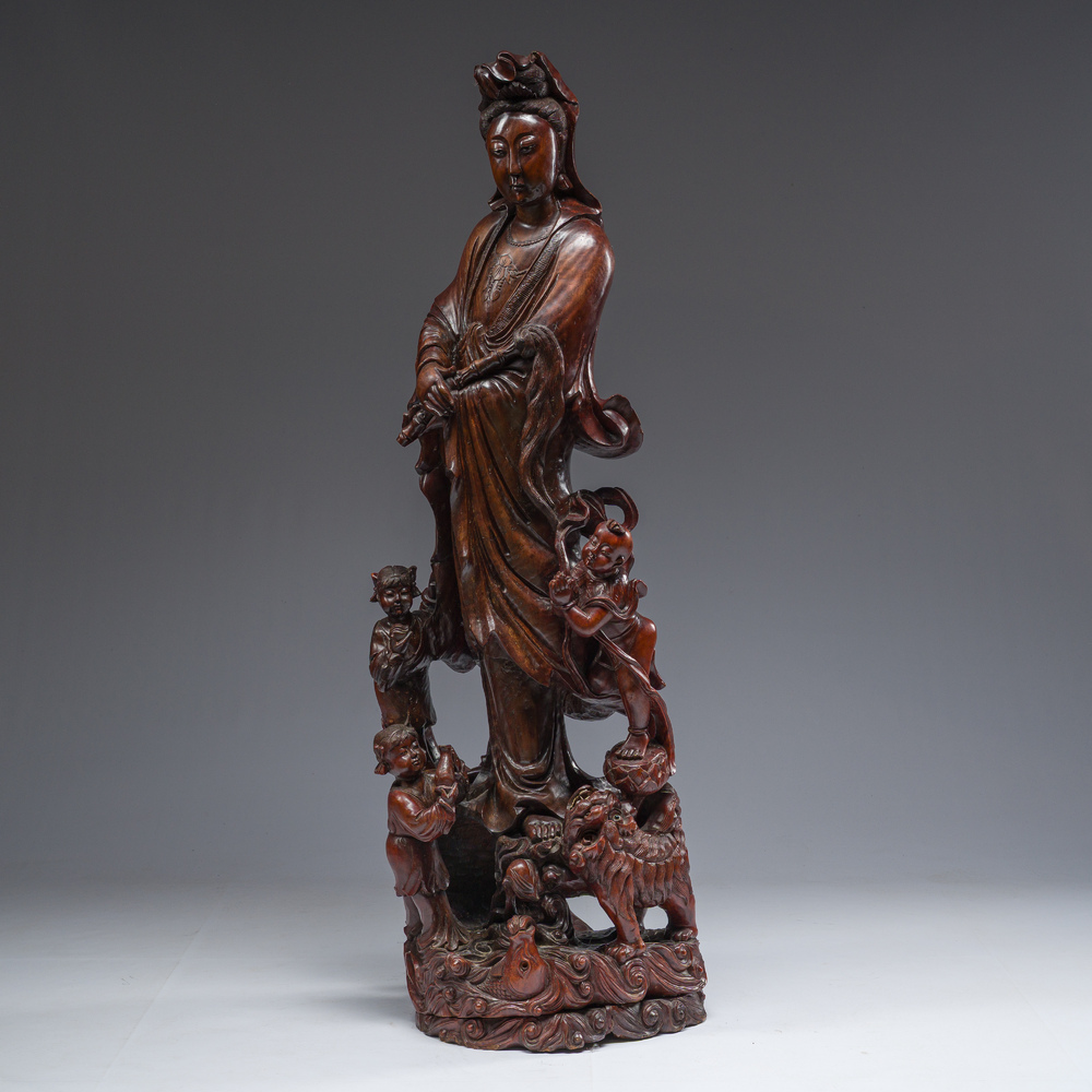 A large Chinese carved wooden figure of Guanyin with children, 20th C.