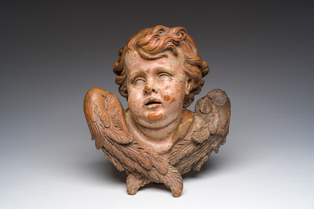 A polychromed terracotta cherub head, probably France, 18th/19th C.