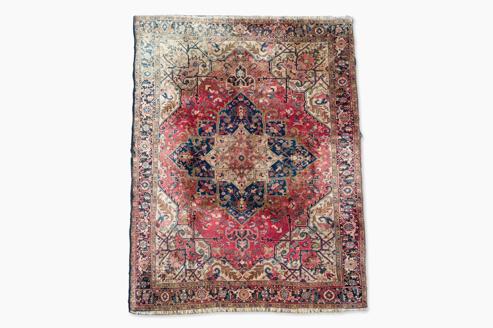 A Persian Heriz rug with floral design, wool on cotton, first half 20th C.