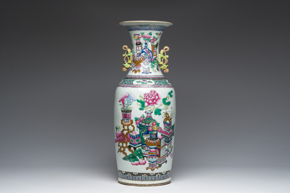 A Chinese famille rose and iron-red vase with a double design of antiquities and Buddhist lions, 19th C.