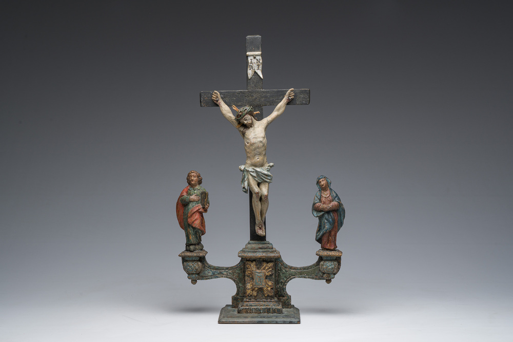 A Spanish polychrome decorated wooden crucifixion group with Jesus on the cross flanked by Mary and John the Evangelist, 18th C.