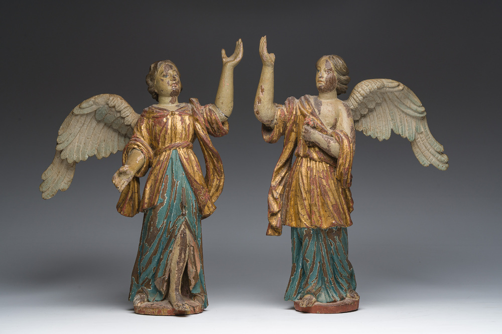 A pair of Italian gilt and polychrome decorated wooden angels, late 18th C.