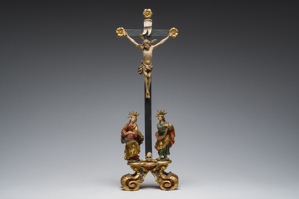An Italian gilt and polychrome decorated wooden crucifixion group with Jesus on the cross flanked by Mary and John the Evangelist, 18th C.