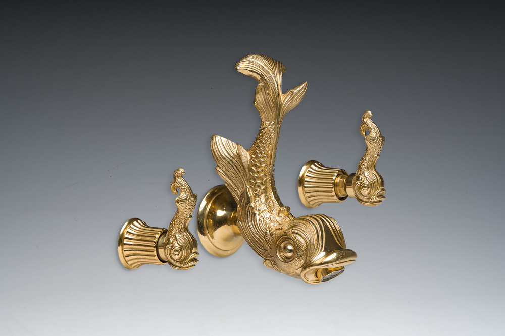 An Italian gilt bronze dolphin-shaped tap and two associated tap buckles, 20th C.