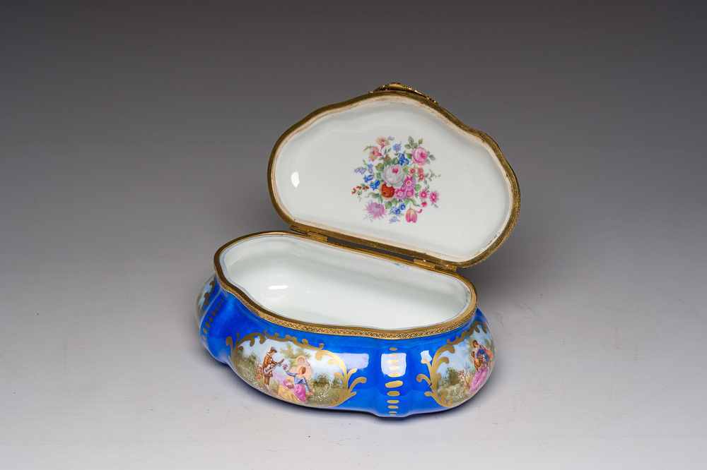 A French gilt and polychrome decorated jewelry box with amorous scenes and floral design, S&egrave;vres mark, 19th/20th C.