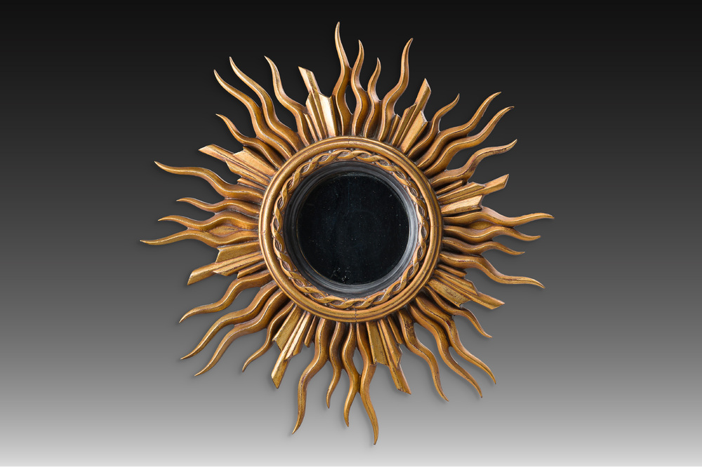 A large gilt and carved wooden sun mirror, 20th C.