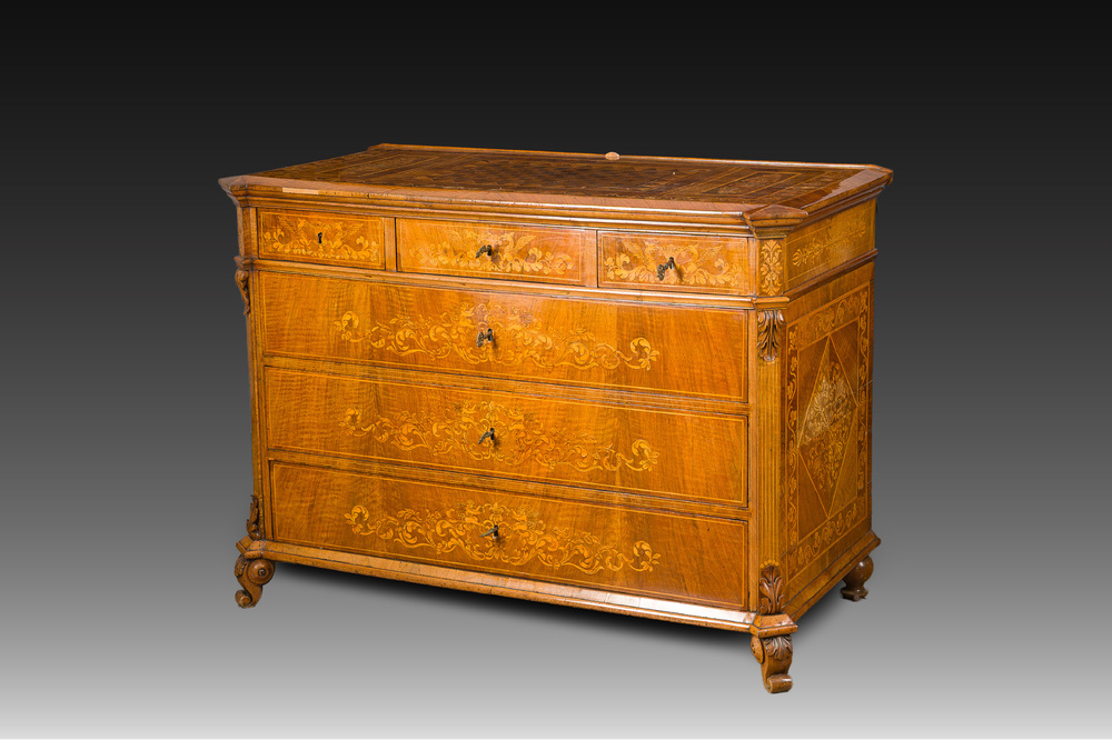 A North Italian commode with four drawers in mahogany and walnut with inlay of sphinxes and flowers in lemonwood, first third 19th C.